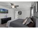 Spacious bedroom with gray upholstered bed and dresser, plus a large TV at 4285 Quote St, Kissimmee, FL 34746