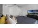 Primary bedroom with large bed, yellow pillows, and ample closet space at 4285 Quote St, Kissimmee, FL 34746