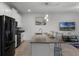 Modern kitchen with island, stainless steel appliances and white cabinets at 4285 Quote St, Kissimmee, FL 34746