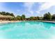 Inviting community pool with lounge chairs and clear water at 6434 Cava Alta Dr # 410, Orlando, FL 32835