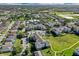 Aerial view of community with pool, tennis courts, and lush landscaping at 8100 Princess Palm Ln # 305, Kissimmee, FL 34747