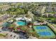Aerial view showing community pool, tennis courts, and surrounding homes at 8100 Princess Palm Ln # 305, Kissimmee, FL 34747