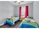 Bright bedroom with two twin beds, nightstand and window at 8100 Princess Palm Ln # 305, Kissimmee, FL 34747