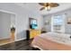 Bedroom with dresser, king-size bed, and view into another room at 8100 Princess Palm Ln # 305, Kissimmee, FL 34747