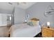 Main bedroom with a queen bed, nightstands and en-suite bathroom at 8100 Princess Palm Ln # 305, Kissimmee, FL 34747