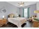Guest bedroom with a queen bed and ceiling fan at 8100 Princess Palm Ln # 305, Kissimmee, FL 34747