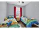 Well-lit bedroom featuring two twin beds with themed bedding at 8100 Princess Palm Ln # 305, Kissimmee, FL 34747