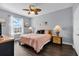 Spacious bedroom with a king-size bed, two nightstands, and large window at 8100 Princess Palm Ln # 305, Kissimmee, FL 34747