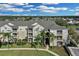 Exterior of a large apartment building with palm trees and landscaping at 8100 Princess Palm Ln # 305, Kissimmee, FL 34747