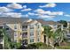Exterior view of the building with palm trees at 8100 Princess Palm Ln # 305, Kissimmee, FL 34747