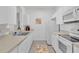 White kitchen with appliances and light countertops at 8100 Princess Palm Ln # 305, Kissimmee, FL 34747