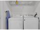 Convenient laundry room with washer, dryer, and shelving at 8100 Princess Palm Ln # 305, Kissimmee, FL 34747