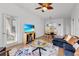 Open living area with hardwood floors, dining area, and access to balcony at 8100 Princess Palm Ln # 305, Kissimmee, FL 34747