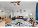 Bright living room features a comfy sectional sofa, coffee table, and hardwood floors at 8100 Princess Palm Ln # 305, Kissimmee, FL 34747
