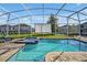 Enjoy this refreshing pool and spa with a projector for outdoor entertainment at 9048 Sand Trap Dr, Davenport, FL 33896