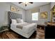 Bedroom with a queen-size bed and tufted headboard at 9048 Sand Trap Dr, Davenport, FL 33896