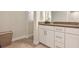 Modern bathroom with white cabinets and a brown countertop at 9248 Hanging Vine Ct, Orlando, FL 32836