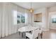 Bright dining area with large windows and oval table at 9248 Hanging Vine Ct, Orlando, FL 32836