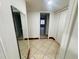 Well-lit hallway with tile flooring and mirrored wall at 4407 S Semoran Blvd # 2, Orlando, FL 32822
