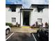 Condo building entrance with stairs and landscaping at 4407 S Semoran Blvd # 2, Orlando, FL 32822