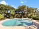 Community pool with surrounding trees at 4407 S Semoran Blvd # 2, Orlando, FL 32822