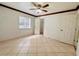 Bright bedroom with tile flooring, ceiling fan, and access to closet at 4407 S Semoran Blvd # 2, Orlando, FL 32822