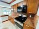 Granite countertops and stainless steel appliances in this kitchen at 4407 S Semoran Blvd # 2, Orlando, FL 32822