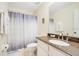 Well-lit bathroom with granite countertop and shower at 8447 Crystal Cove Loop, Kissimmee, FL 34747