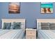 Guest bedroom with twin beds and calming blue decor at 18357 Mowry Ct, Orlando, FL 32827