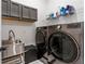Laundry room with washer, dryer, and utility sink at 18357 Mowry Ct, Orlando, FL 32827