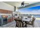 Outdoor kitchen with dining area and lake view at 18357 Mowry Ct, Orlando, FL 32827
