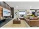 Living room with a leather sectional sofa and sliding doors leading to a patio at 18357 Mowry Ct, Orlando, FL 32827