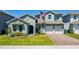 Two story house with a two car garage and a nicely landscaped lawn at 18357 Mowry Ct, Orlando, FL 32827