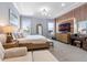 Main bedroom with large TV, sitting area, and water views at 18357 Mowry Ct, Orlando, FL 32827