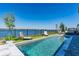 Inviting pool area with lake view and lounge chairs at 18357 Mowry Ct, Orlando, FL 32827