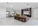 Spacious living room with marble floors, a large TV, and leather furniture at 18357 Mowry Ct, Orlando, FL 32827