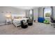Spacious bedroom with king-size bed, two accent chairs, and a workspace at 18357 Mowry Ct, Orlando, FL 32827