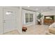 Bright living room with tiled floors and large windows at 2570 Turnbull Bay Rd, New Smyrna Beach, FL 32168