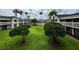 Complex courtyard with green space and tropical trees at 5245 W Irlo Bronson Memorial Hwy # 154, Kissimmee, FL 34746