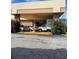Main entrance to the building with a covered awning, fountain, and parking area at 7900 S Orange Blossom Trl # 2097, Orlando, FL 32809