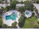 Aerial view of community pool and hot tub with surrounding landscaping at 7900 S Orange Blossom Trl # 2097, Orlando, FL 32809