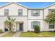 Two-story townhome with gray siding and blue shutters at 2412 Dubai St, Kissimmee, FL 34747