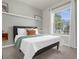 Cozy bedroom with a queen-size bed and large window at 2412 Dubai St, Kissimmee, FL 34747
