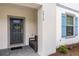 Front door with light gray walls and blue shutters at 2412 Dubai St, Kissimmee, FL 34747