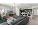 Open living room with sectional sofa and kitchen island at 2412 Dubai St, Kissimmee, FL 34747