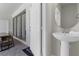 Convenient half bathroom with pedestal sink, perfect for guests at 2412 Dubai St, Kissimmee, FL 34747