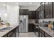 Modern kitchen with stainless steel appliances and granite countertops at 2412 Dubai St, Kissimmee, FL 34747