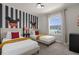 Fun bedroom with twin beds, Mickey Mouse theme, and natural light at 2412 Dubai St, Kissimmee, FL 34747