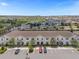 Aerial view of townhouses with parking and a pond in the background at 2412 Dubai St, Kissimmee, FL 34747
