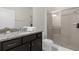 Clean bathroom with granite vanity and walk-in shower at 2412 Dubai St, Kissimmee, FL 34747